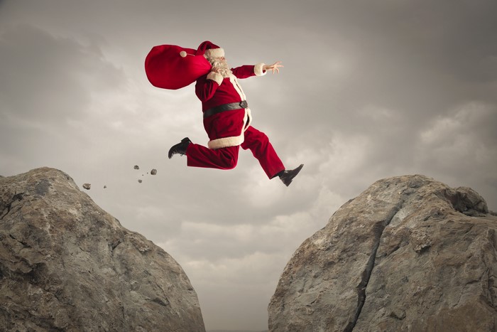 Santa Claus jumping between rocks
