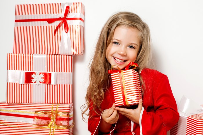 Little girl with Christmas gifts