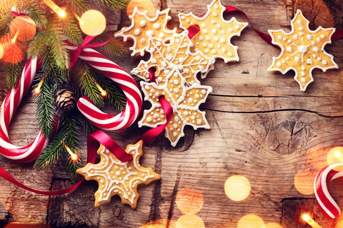 Christmas cookies and candy canes on wood