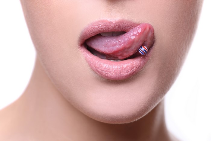 Closeup of lips and tongue with piercing