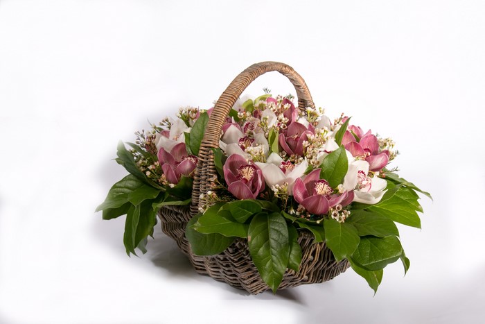 Orchid flower arrangement in a wicker basket