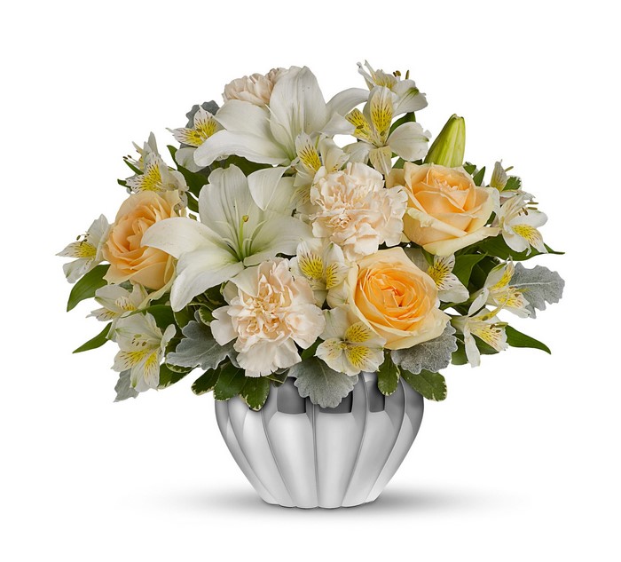White lilies, peach roses, carnations, and alstroemeria in a silver vase