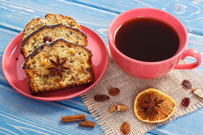 Slices of fruitcake with star anise and coffee
