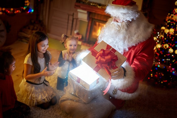 Santa Claus giving gifts to happy children