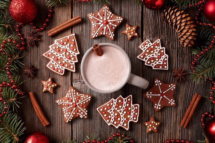 Christmas gingerbread cookies and hot chocolate on wood