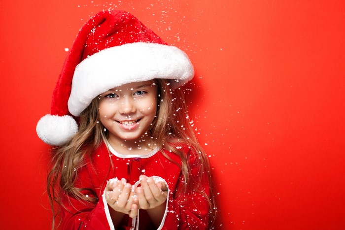 Girl in Santa hat with snowflakes
