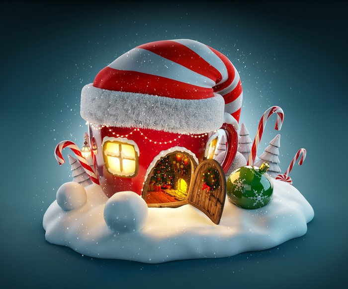 Christmas scene with a house shaped like a mug and Santa hat