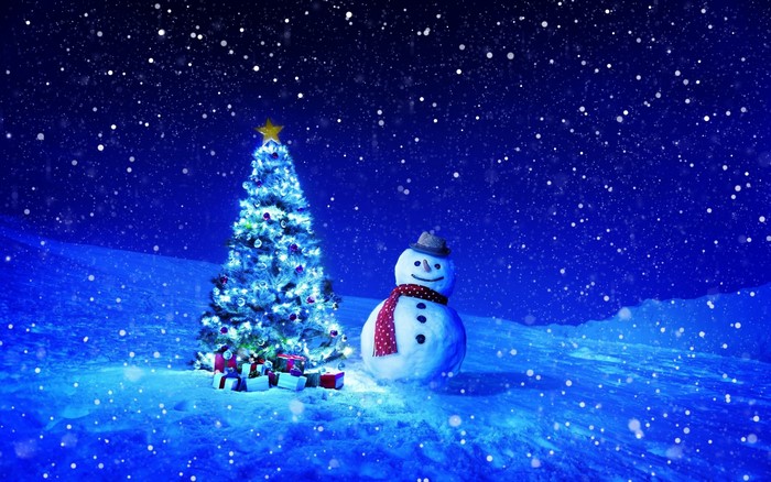 Christmas tree and snowman in a snowy night