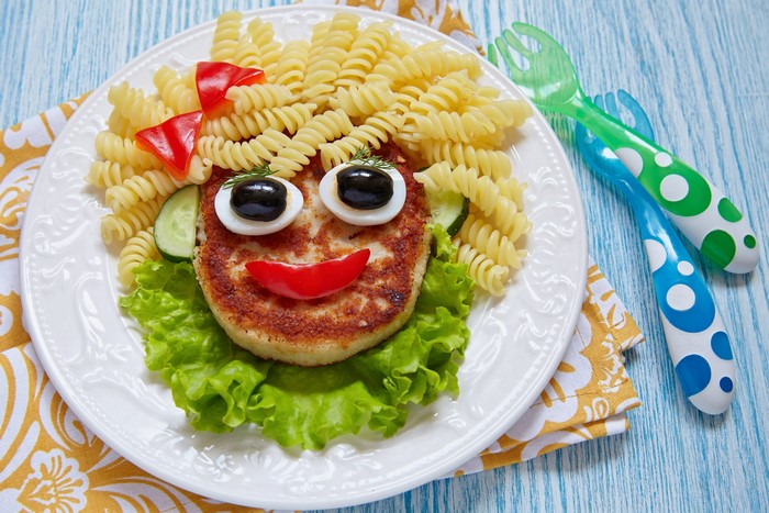 Food art face with pasta hair on a plate