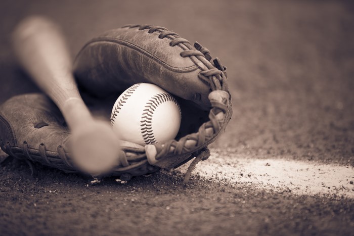 Baseball bat, ball, and glove on field