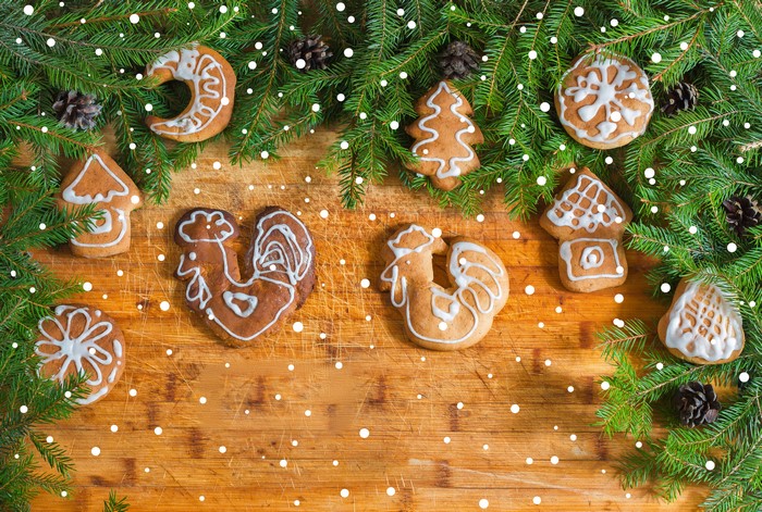 Christmas gingerbread cookies with fir branches on wood