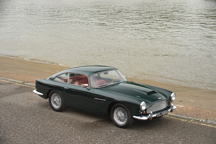 Green Aston Martin DB4 Series II by the water