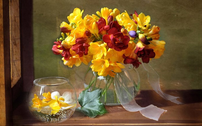 Bouquet of yellow and red freesias in a vase
