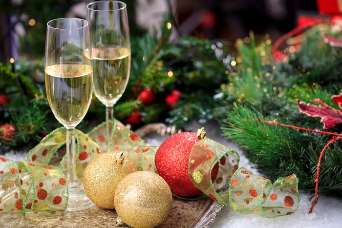 Champagne glasses with Christmas ornaments and ribbon