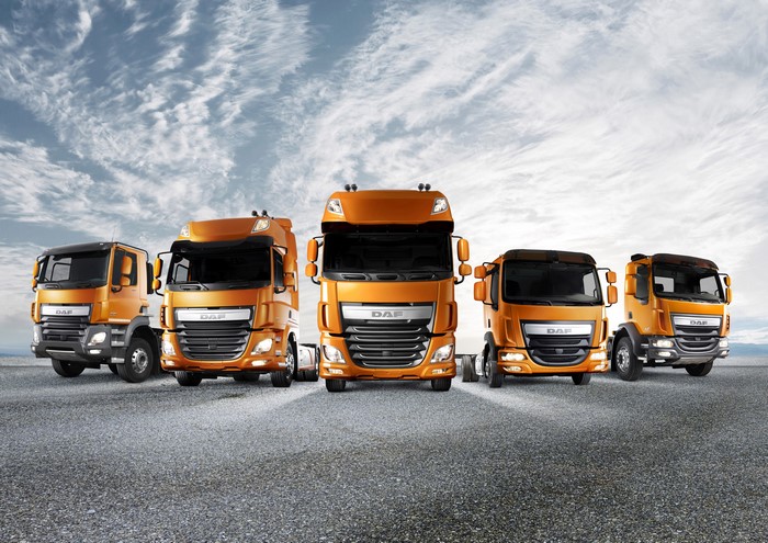 Five orange DAF trucks lined up