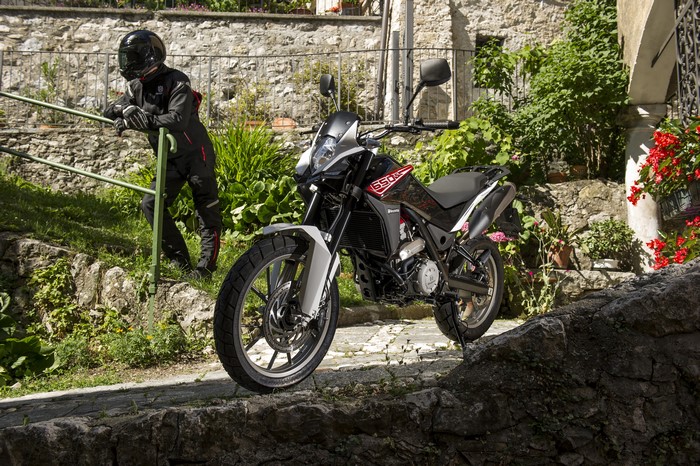 Motorcyclist in uniform with 2012-16 Husqvarna TR 650 Strada