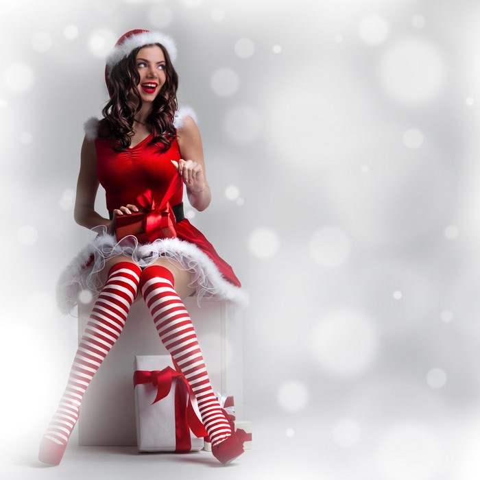 Woman in Santa costume with Christmas gifts