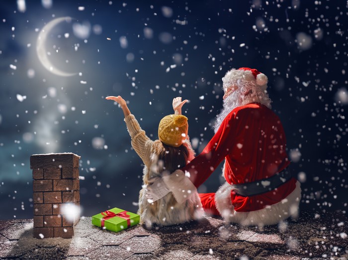 Santa Claus and girl on roof at night
