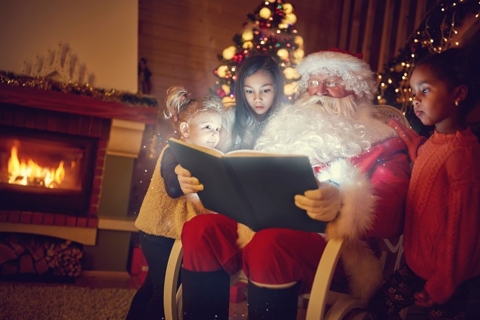 Santa Claus Reading a Book to Three Girls