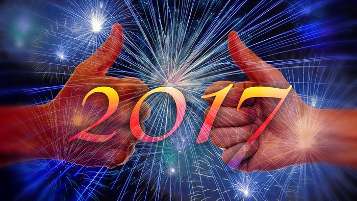 Two hands giving thumbs up with 2017 and fireworks