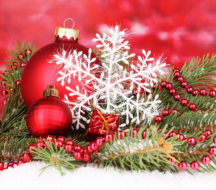 Christmas ornaments, pine branches, and snowflakes on snow