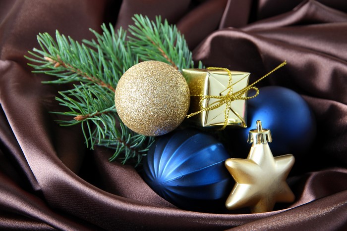 Christmas ornaments on brown satin with pine branch
