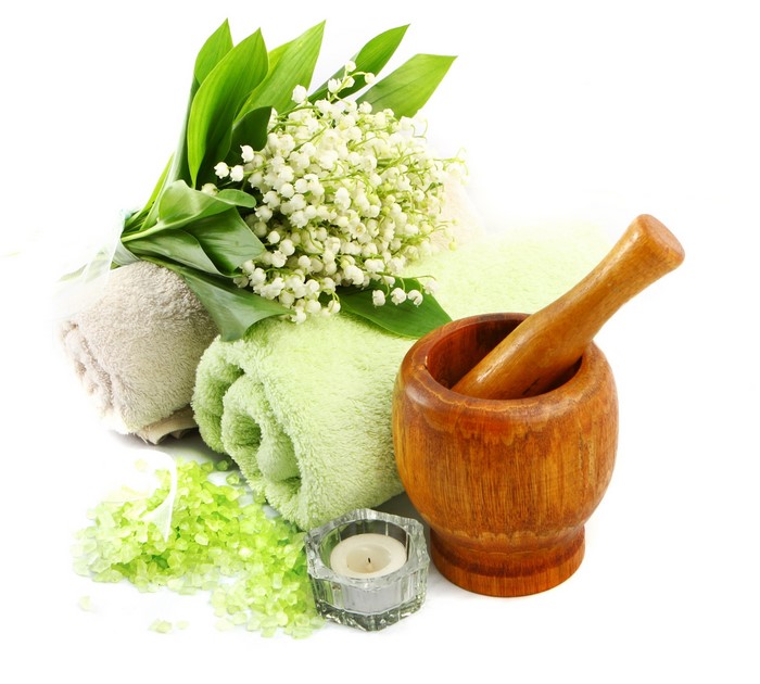 Spa setting with lilies of the valley, towels, and mortar