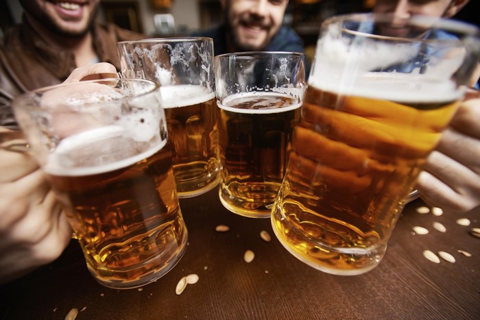 Friends toasting with beer mugs