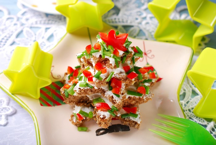 Christmas tree shaped appetizer with cream cheese and vegetables