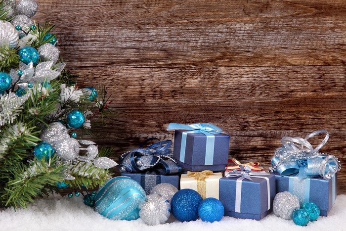 Christmas tree with ornaments and gifts on wood planks