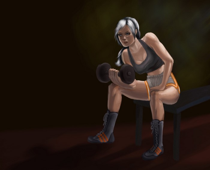 Woman lifting dumbbells on a bench
