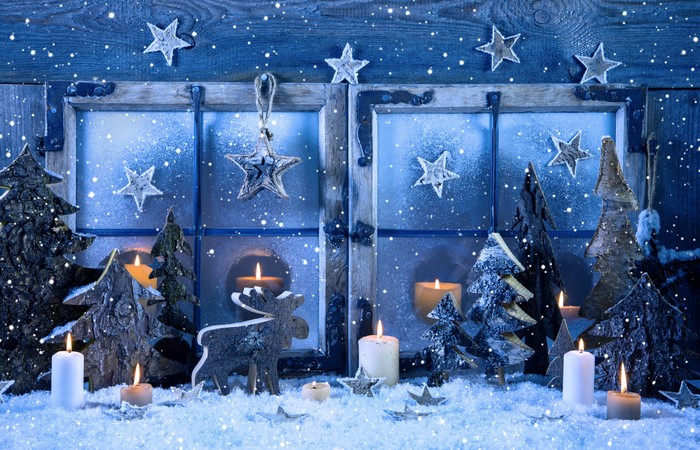 Christmas window with candles, trees, and stars