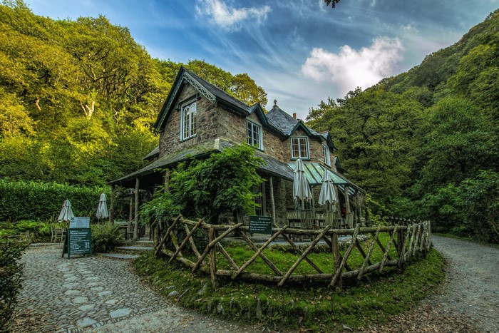Stone house with a wooden fence in Lynmouth, England
