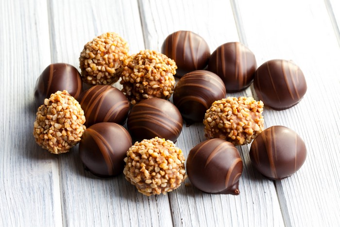 Assortment of chocolates on wood planks