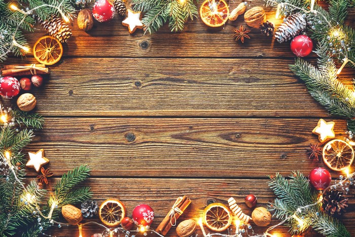 Christmas decorations on wooden planks with fairy lights
