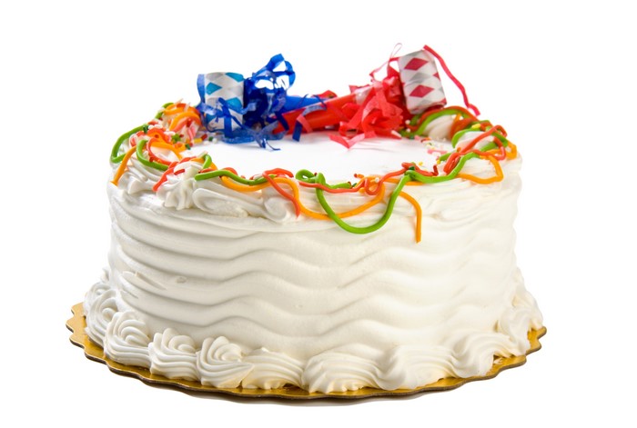 White cake with party streamers and decorations