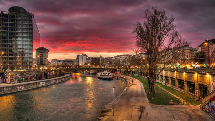 Vienna canal at sunset with buildings and boats