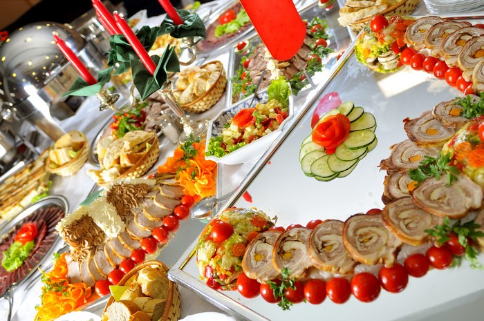 Buffet table with meat, salads, and bread