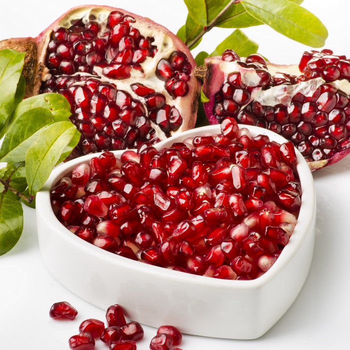 Pomegranate seeds in a heart-shaped bowl