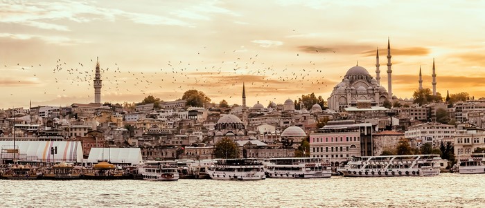 Istanbul cityscape with mosques and ships at sunset