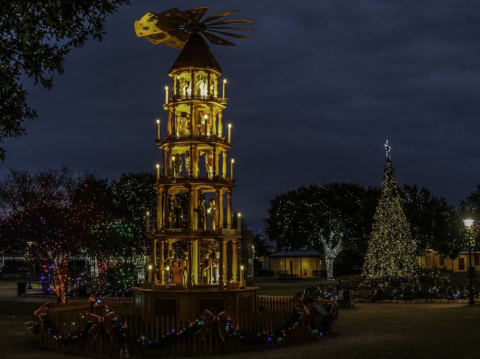 Christmas pyramid and tree with fairy lights at night in Fredericksburg, Texas