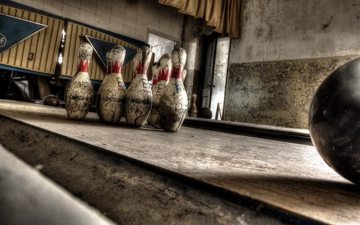 Abandoned bowling alley with pins and ball