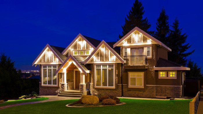Luxury house with lawn at night