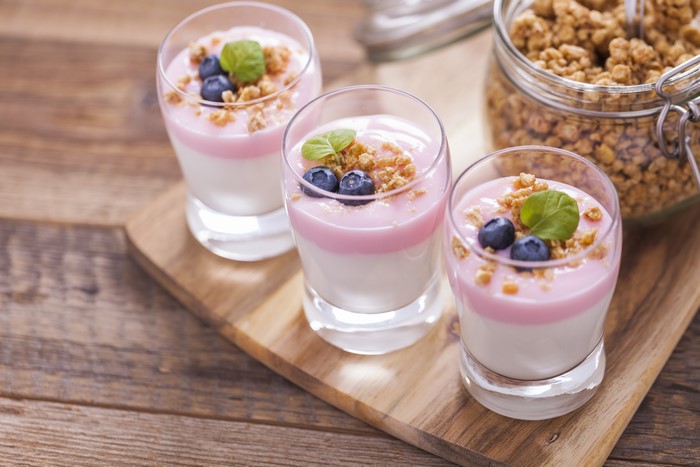 Dessert with blueberries and granola in glasses