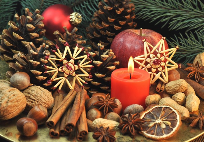 Christmas still life with candle, pine cones, and nuts