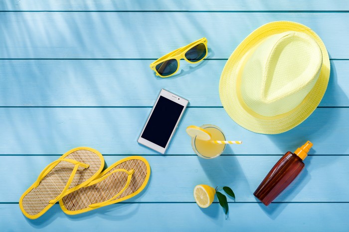 Summer accessories on blue wooden planks