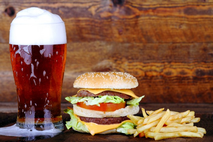 Beer, Hamburger, and French Fries on a Wooden Table