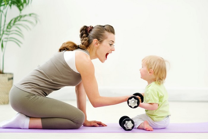 Mother and baby exercising with dumbbells