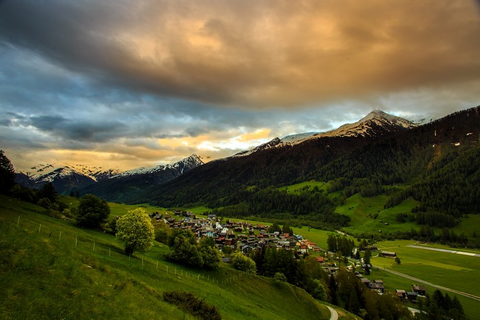 4K Munster Goms Switzerland Mountains Houses Fields Forests Clouds