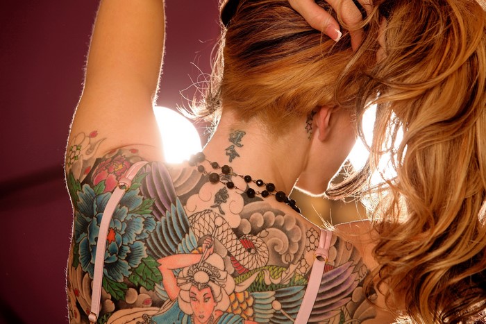 Woman with large colorful back tattoo